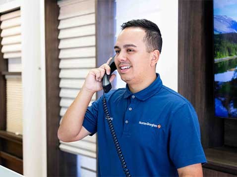 Man smiling and holding a telephone