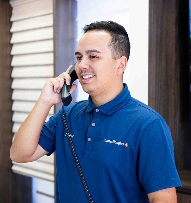 Man smiling and holding a telephone